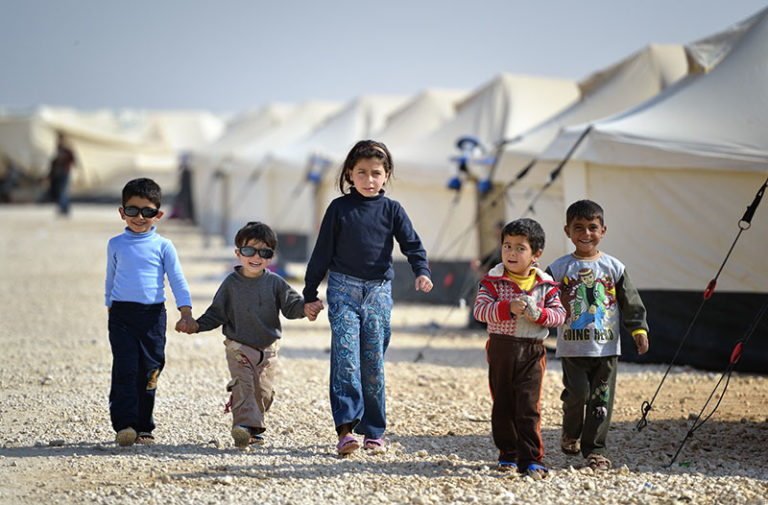 Children walking in the Zaatari Refugee Camp, located near Mafraq, Jordan. Opened in July, 2012, the camp holds upwards of 20,000 refugees from the civil war inside Syria. International Orthodox Christian Charities and other members of the ACT Alliance are active in the camp providing essential items and services.